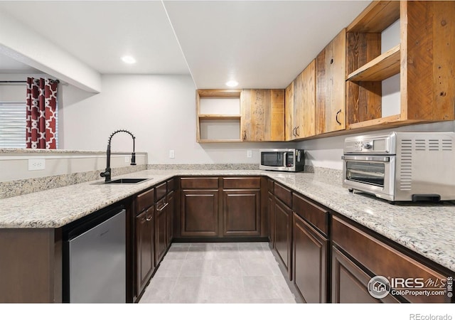 kitchen with a toaster, dishwasher, stainless steel microwave, open shelves, and a sink