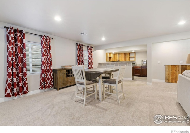 dining space with light carpet, baseboards, visible vents, and recessed lighting