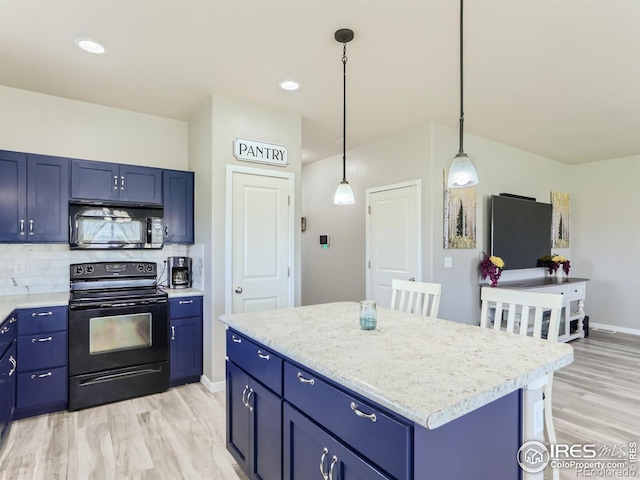 kitchen featuring a center island, black appliances, hanging light fixtures, light wood-type flooring, and blue cabinetry