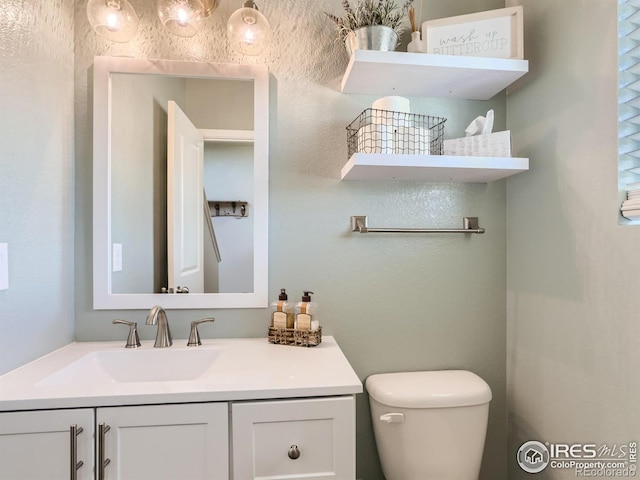 bathroom featuring vanity and toilet