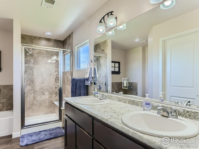 bathroom with vanity, shower with separate bathtub, and hardwood / wood-style flooring