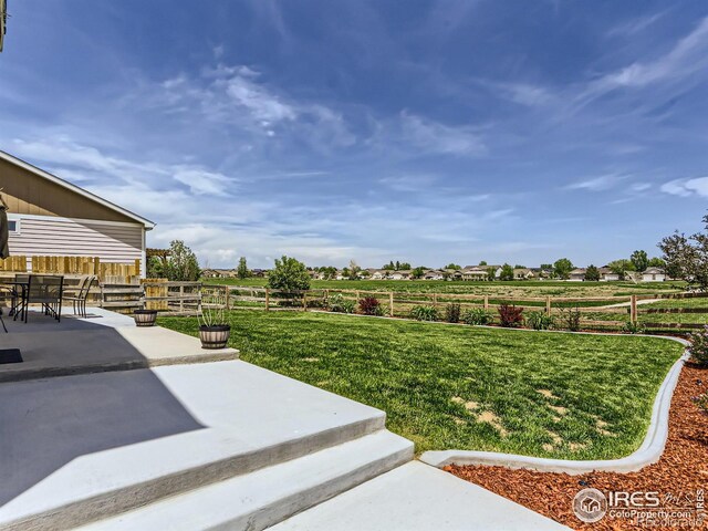 view of yard featuring a patio area and a rural view