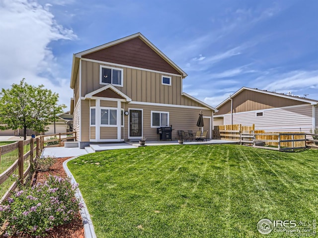 back of property featuring a patio area and a yard