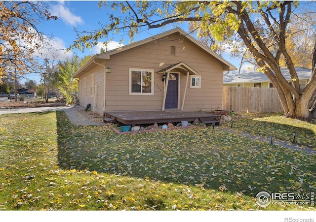 bungalow-style home with a front yard