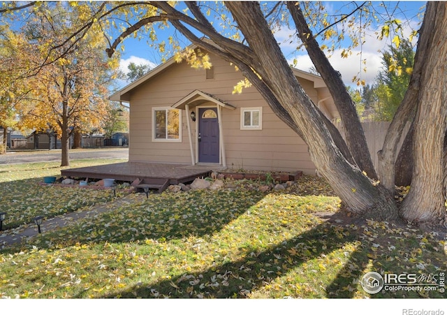 bungalow-style house featuring a front yard