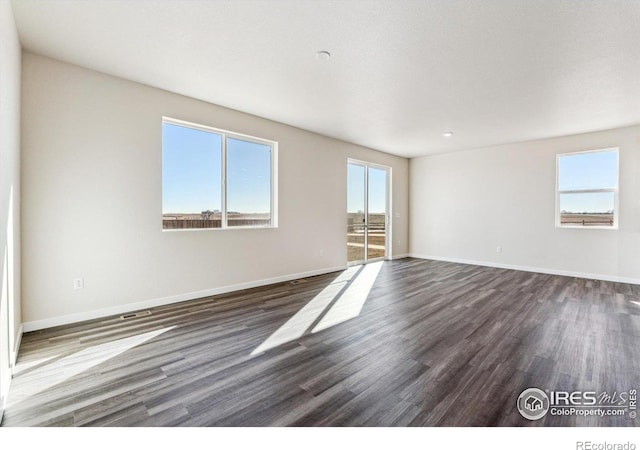 spare room featuring dark hardwood / wood-style floors