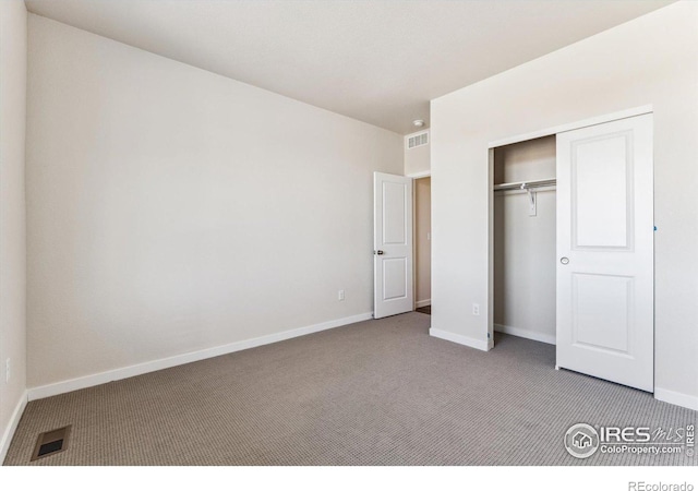 unfurnished bedroom with a closet and carpet