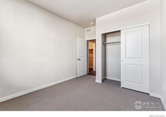 unfurnished bedroom with carpet and a closet