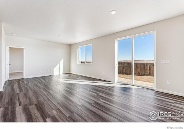 unfurnished room featuring dark hardwood / wood-style flooring