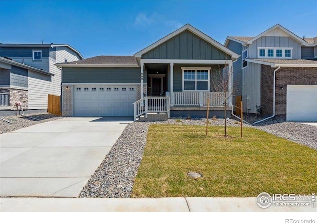 909 Harvard St, Johnstown, CO 80534 - craftsman house featuring board and batten siding, a porch, driveway, a front yard, and an attached garage