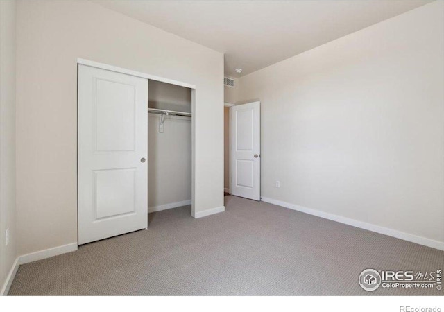 909 Harvard St, Johnstown, CO 80534 - unfurnished bedroom with carpet floors, baseboards, visible vents, and a closet