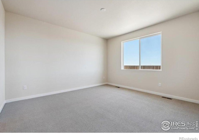 909 Harvard St, Johnstown, CO 80534 - carpeted empty room with visible vents and baseboards
