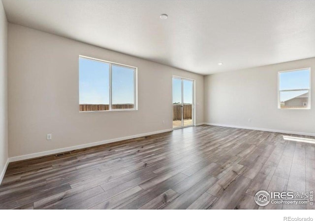 909 Harvard St, Johnstown, CO 80534 - unfurnished room with baseboards, wood finished floors, and visible vents