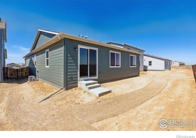 909 Harvard St, Johnstown, CO 80534 - rear view of house featuring central AC unit and entry steps