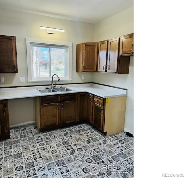 kitchen with light tile patterned flooring and sink