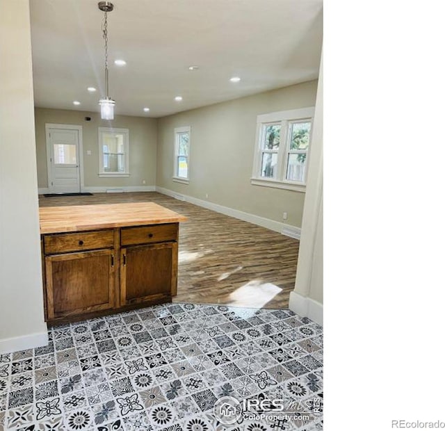 kitchen with decorative light fixtures, light wood-type flooring, and butcher block counters