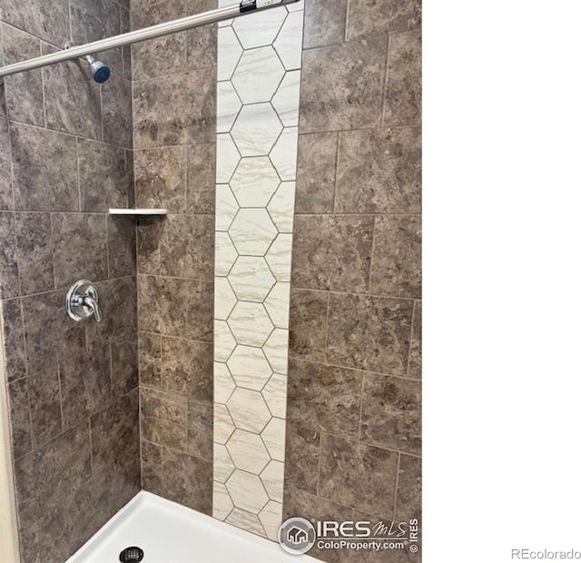 bathroom with a tile shower