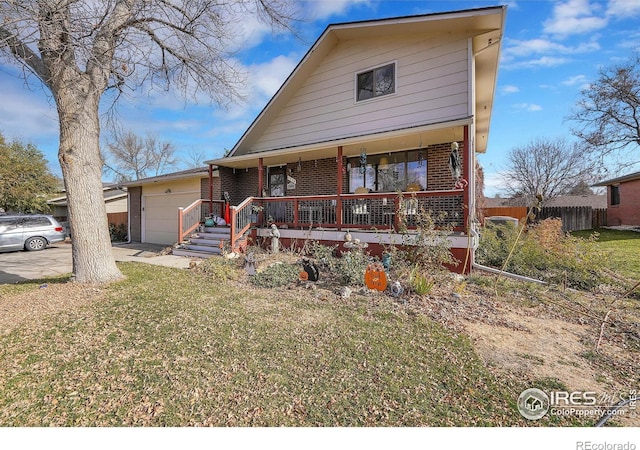 view of front facade featuring a garage, a porch, and a front yard