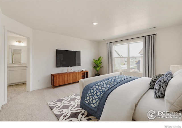 carpeted bedroom with connected bathroom