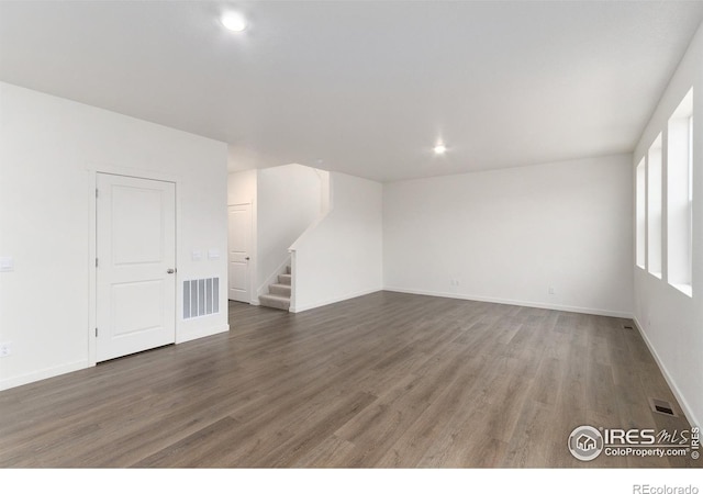 unfurnished room with dark hardwood / wood-style floors