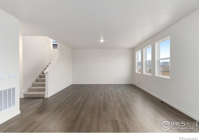 spare room featuring dark wood-type flooring