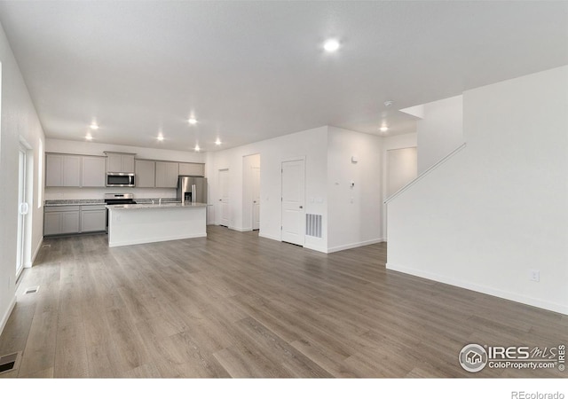 unfurnished living room with hardwood / wood-style flooring