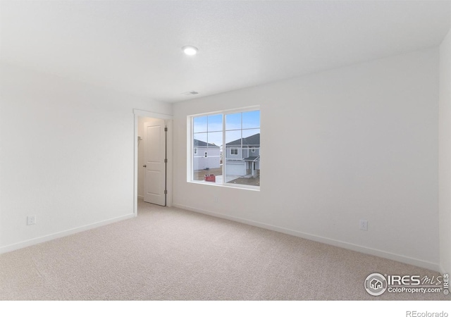 unfurnished room with light colored carpet