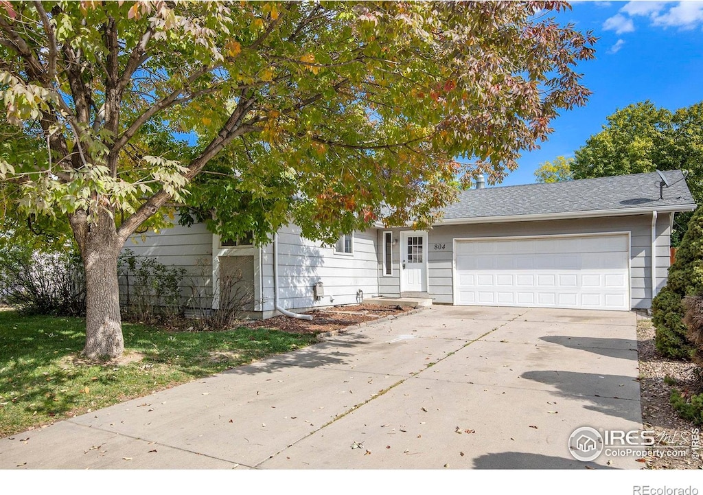 obstructed view of property with a garage