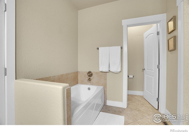 bathroom featuring tile patterned flooring and a bath