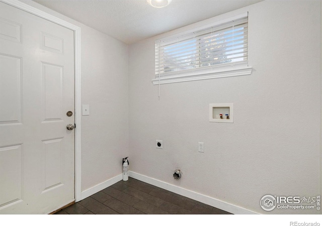 laundry area featuring a textured ceiling, hookup for a washing machine, dark hardwood / wood-style floors, and hookup for an electric dryer