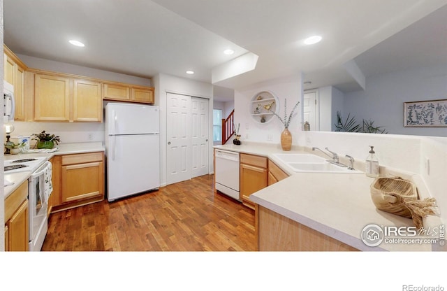 kitchen with wood-type flooring, white appliances, sink, and light brown cabinetry