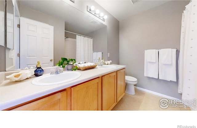 bathroom with tile patterned floors, vanity, curtained shower, and toilet