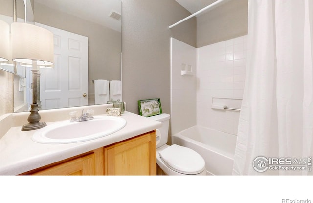 full bathroom featuring vanity, shower / bath combination with curtain, and toilet