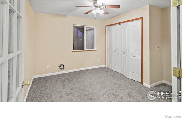 unfurnished bedroom featuring ceiling fan, a closet, and carpet floors