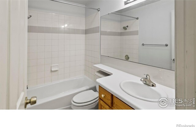 full bathroom featuring vanity, toilet, and tiled shower / bath