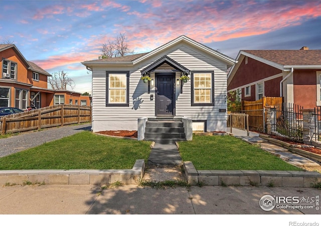 bungalow-style home featuring a lawn