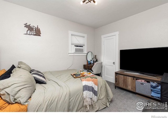 bedroom with cooling unit and carpet floors