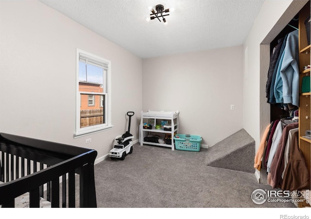 carpeted bedroom with a textured ceiling