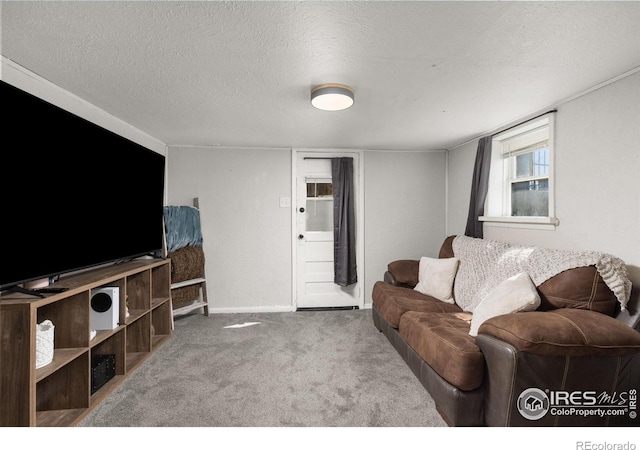 carpeted living room featuring a textured ceiling