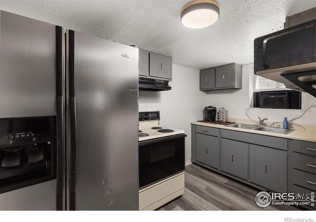 kitchen with dark wood-type flooring, sink, stainless steel fridge with ice dispenser, gray cabinets, and white range with electric cooktop