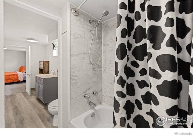 full bathroom featuring shower / bath combination with curtain, toilet, wood-type flooring, and vanity