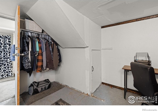 walk in closet featuring lofted ceiling