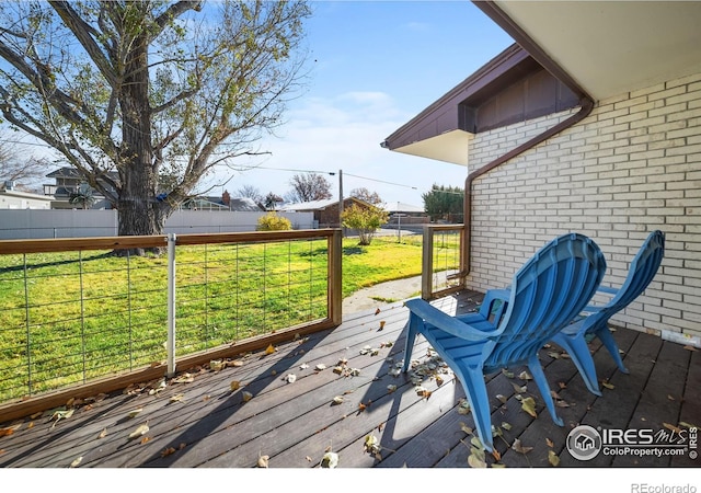 wooden terrace with a lawn