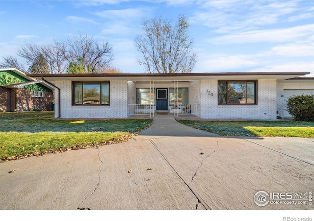 ranch-style house with a porch and a front yard