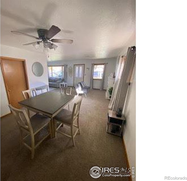 dining space featuring dark colored carpet, ceiling fan, and a healthy amount of sunlight