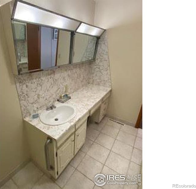 bathroom with decorative backsplash, vanity, and tile patterned floors