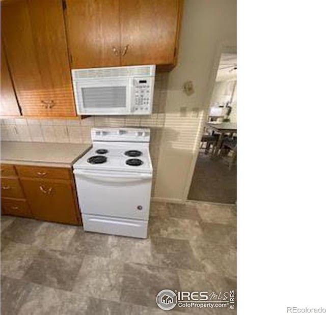 kitchen with white appliances and tasteful backsplash