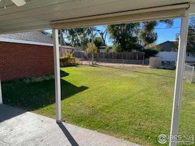 view of yard with a patio and ceiling fan