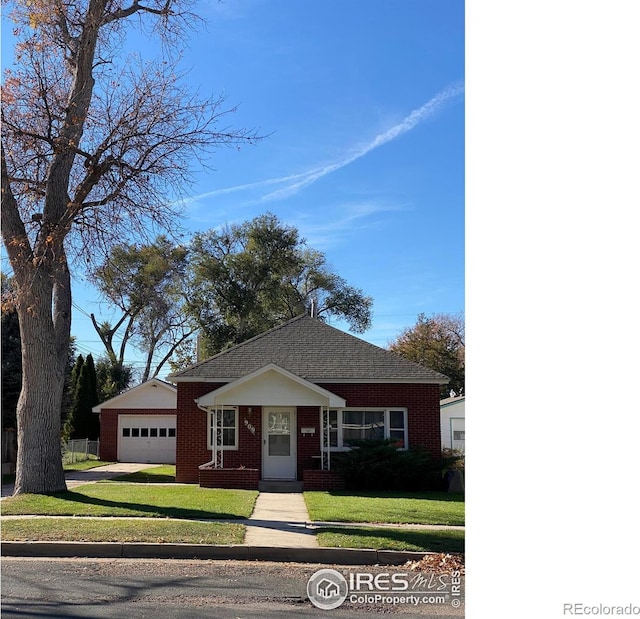 ranch-style house with a front yard and a garage