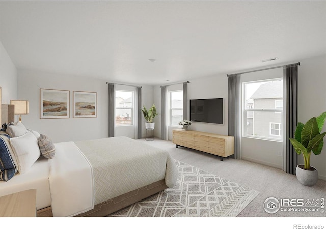 carpeted bedroom featuring multiple windows